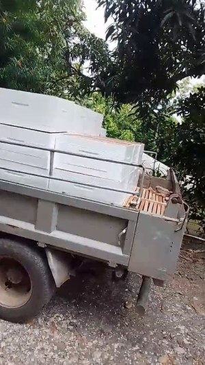Locally made beehive boxes loaded on a truck in Jamaica