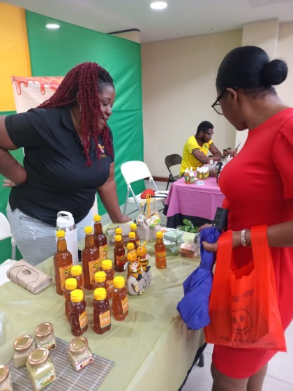 Honeylishus founder Nadia Johnson with a customer at the FarmHers Market in Jamaica